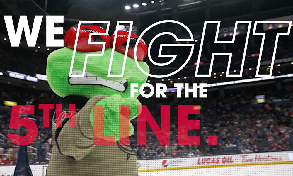 Columbus Blue Jacket hockey rink with text overlay "We fight for the 5th line" text overlay and a green mascots