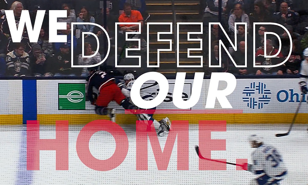 CBJ Hockey rink with "We defend our home" text overlayed in all caps