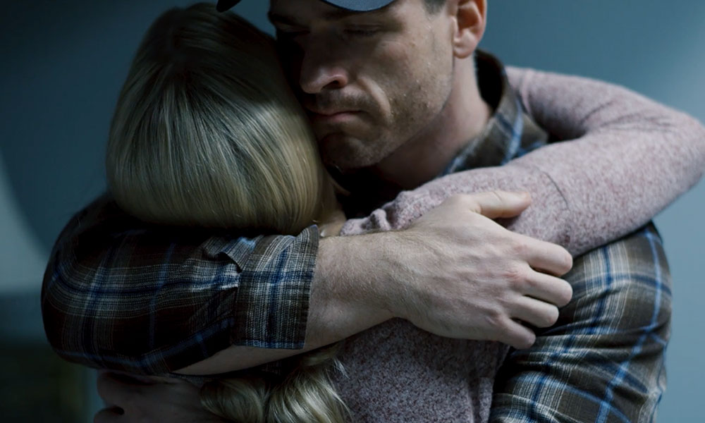 A close-up image of two people hugging, conveying comfort and support.