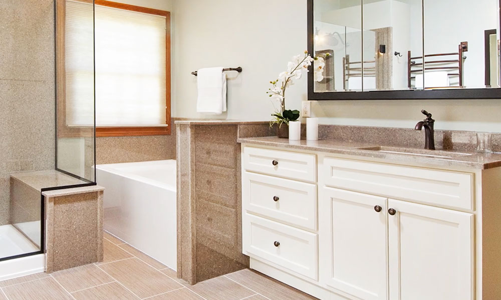 Image of a beige bathroom with broze fixtures and nice bathtub