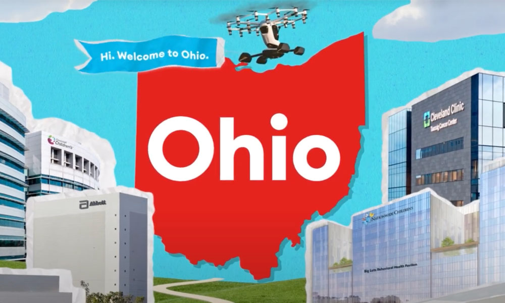 Ohio state illustration in red against a city scape with a blue banner saying "Hi. Welcome to Ohio"